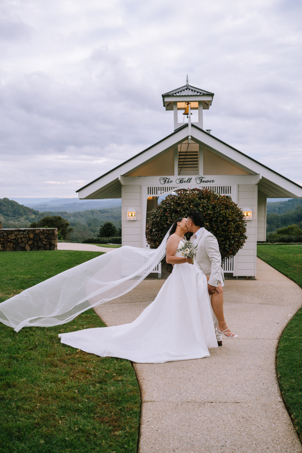 couple at the bell tower at the old dairy maleny