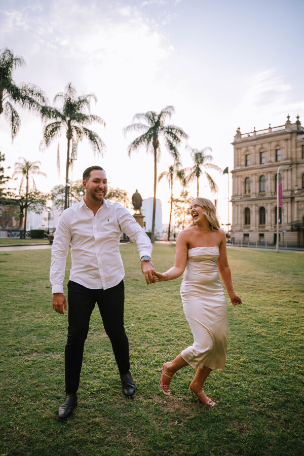Holding hands during golden hour in Queen’s Gardens engagement shoot
