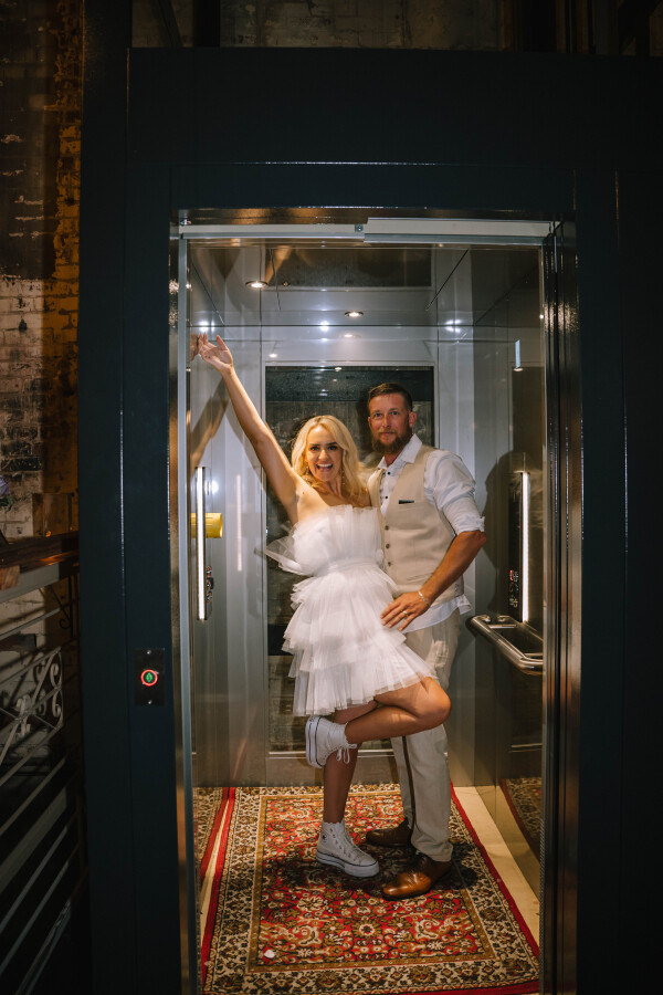 couple posing in lift at smoked garage wedding venue in fortitude valley, brisbane