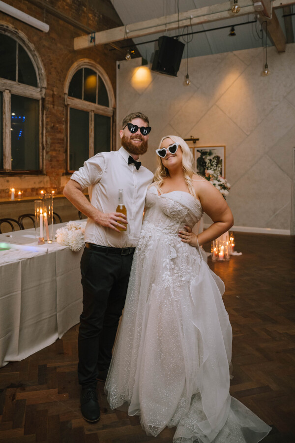 couple wearing heart sunnies at wedding reception at the warehouse brisbane venue