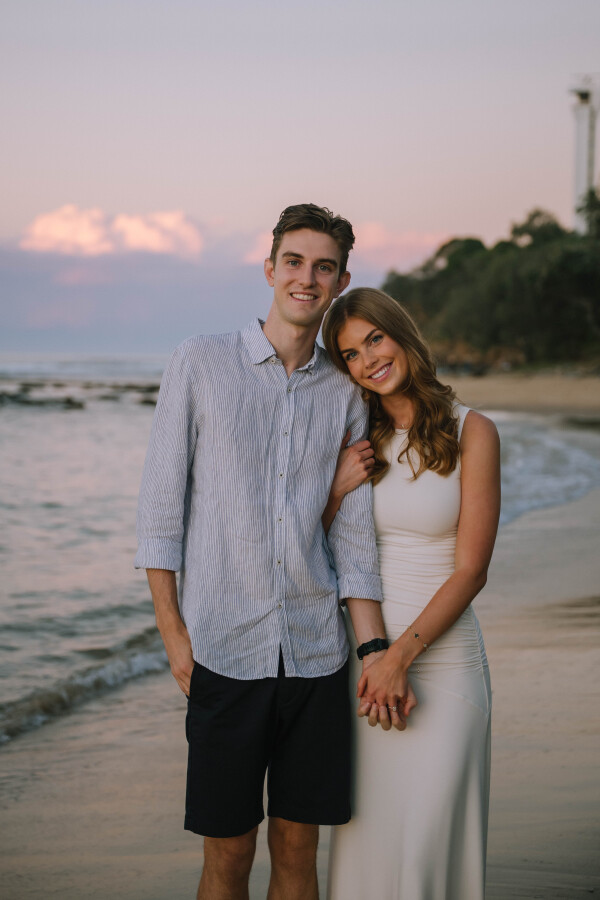 Holding hands at golden hour during Point Cartwright engagement photo session