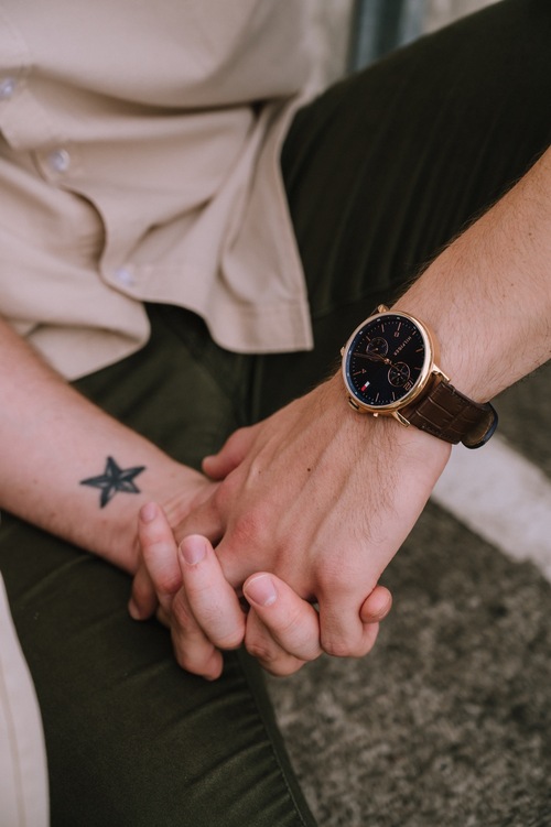 close up of couple holding hands during rooftop engagement photography session in brisbane