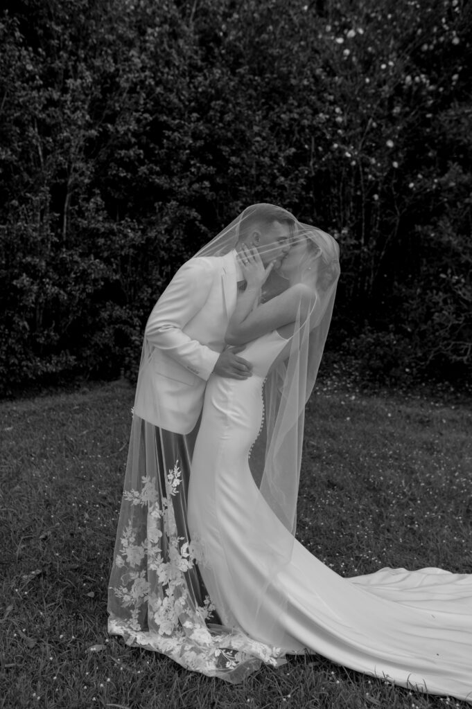 couple kissing under bride's veil at montvale at montville wedding in the sunshine coast hinterland