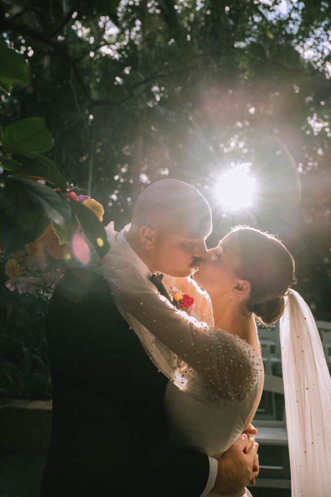 close-up of couple kissing during golden hour portraits at sunshine coast wedding