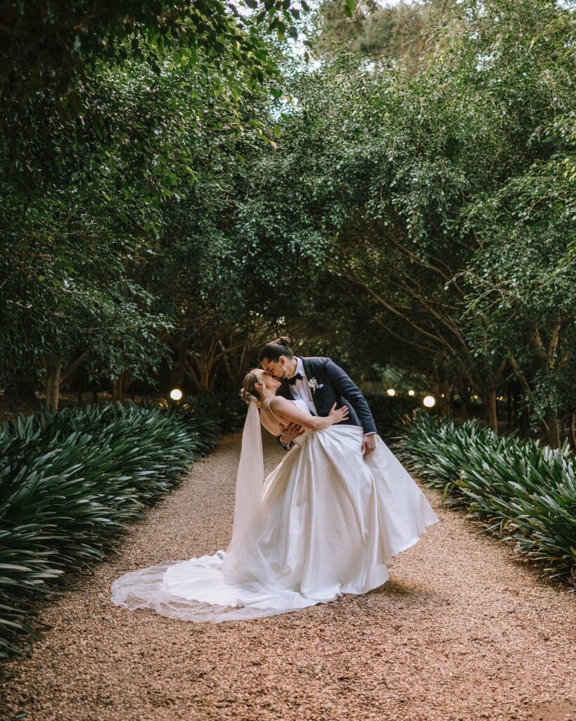 editorial portrait of bride and groom kissing during couple portraits after wedding ceremony