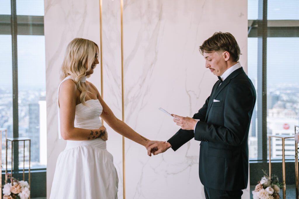 groom getting emotional reading vows during intimate brisbane registry elopement ceremony