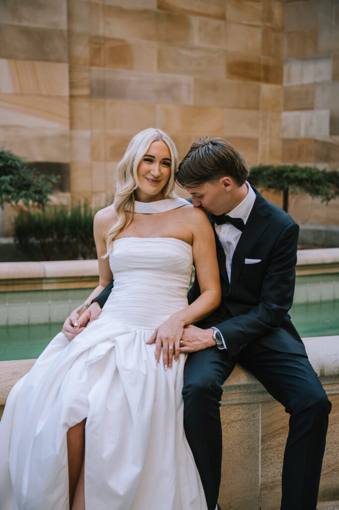 groom kissing bride's shoulder during couple portraits after registry elopement