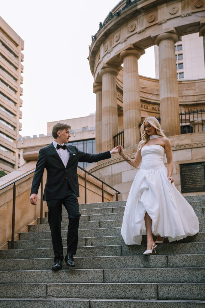 bride and groom walking down stairs during couple portraits