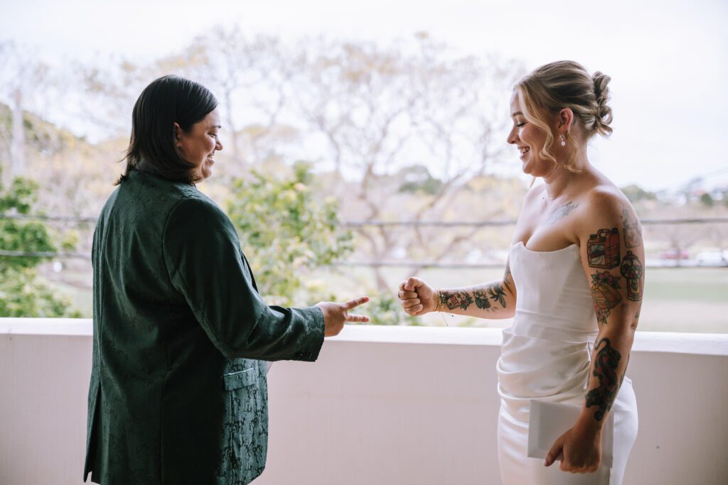 brides playing paper scissors rock during private vows at emporium hotel southbank