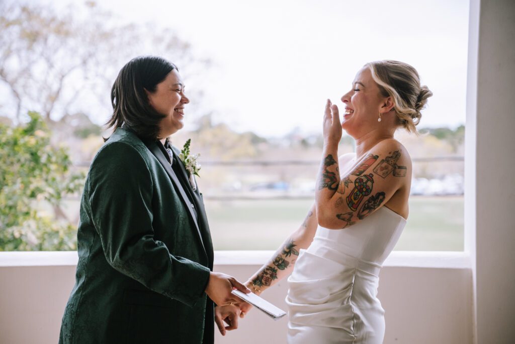 brides laughing during private vows before elopement ceremony 