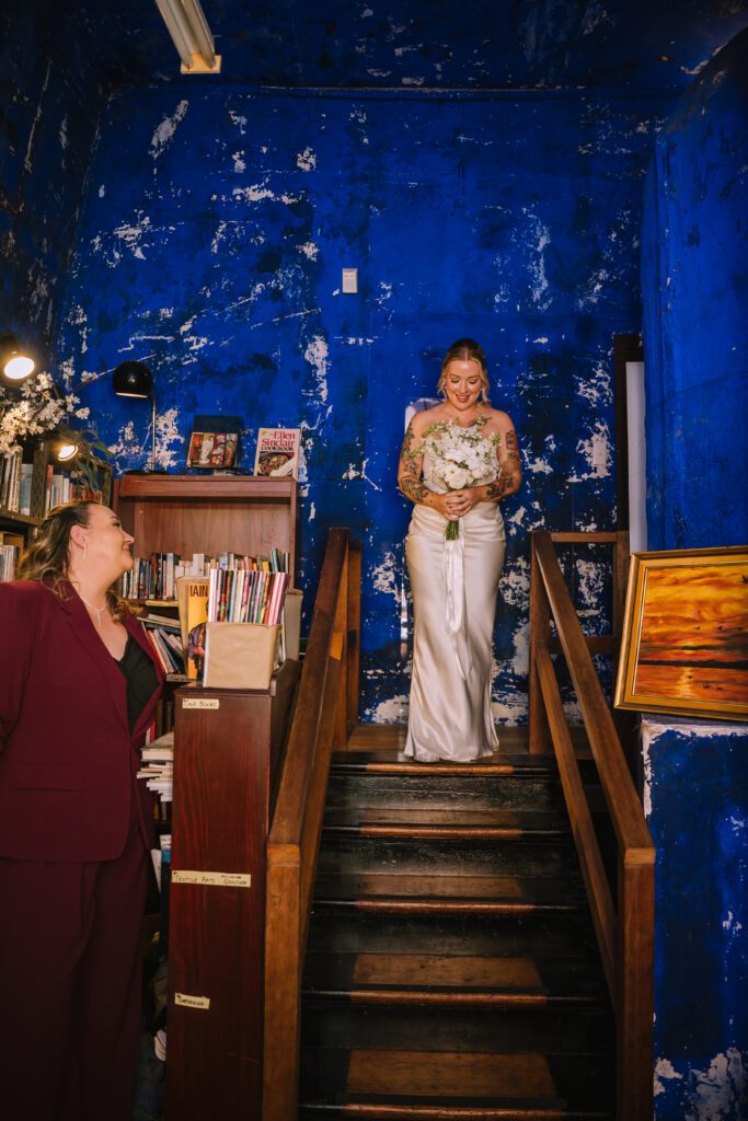 bride arriving at elopement ceremony in empire revival antique store 