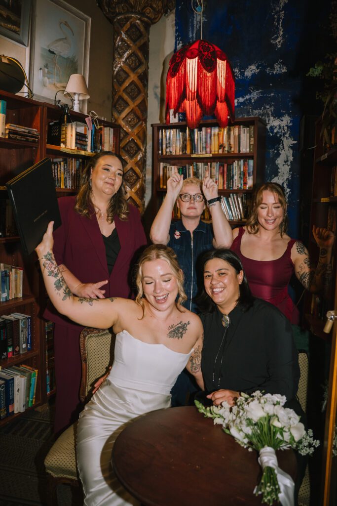 couple celebrating after officially eloping at empire revival