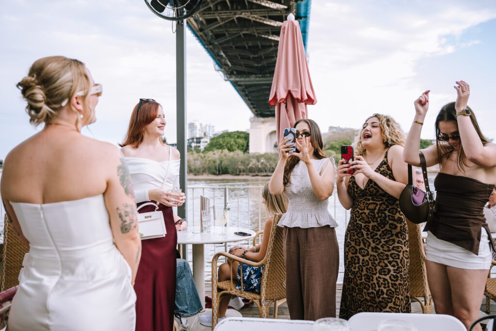 friends greeting the newly eloped couple as they arrive at mr percivals at howard smith wharves