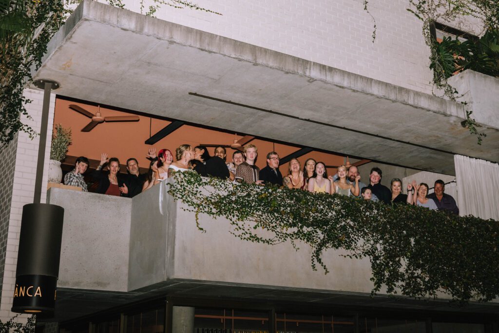 couple celebrating with their guests on the rooftop at bianca restaurant in fortitude valley 