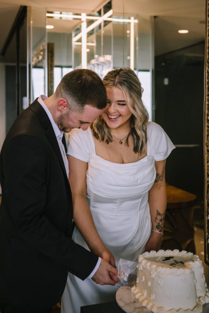 couple cutting just married cake after elopement at emporium hotel southbank in brisbane