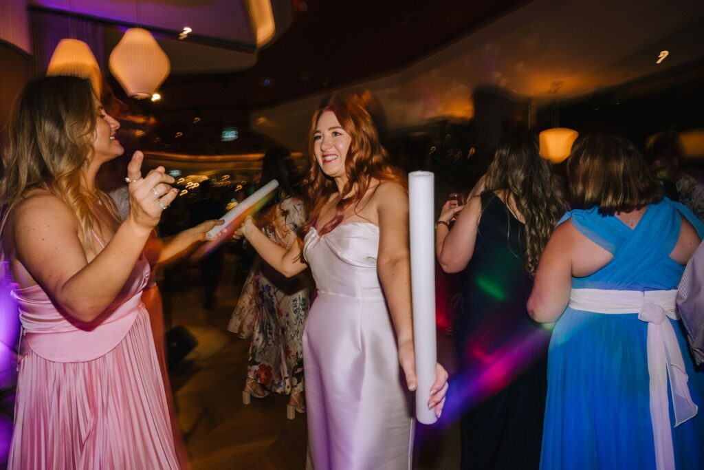 documentary style wedding photo of bride with guests on the dancefloor 