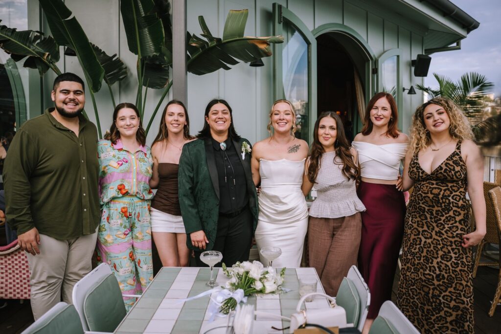 couple posing with friends during afternoon drinks at Howard Smith Wharves after brisbane elopement