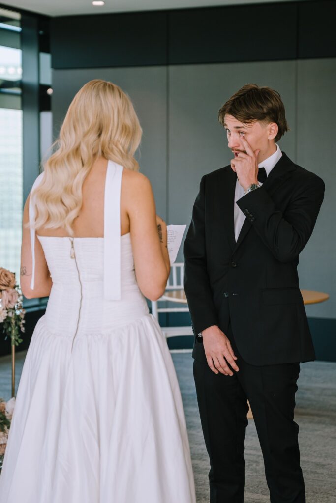 groom wiping a tear during intimate elopement ceremony at the brisbane registry office 