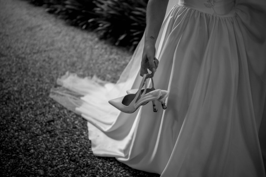 black and white editorial style close up shot of bride holding slickbacks
