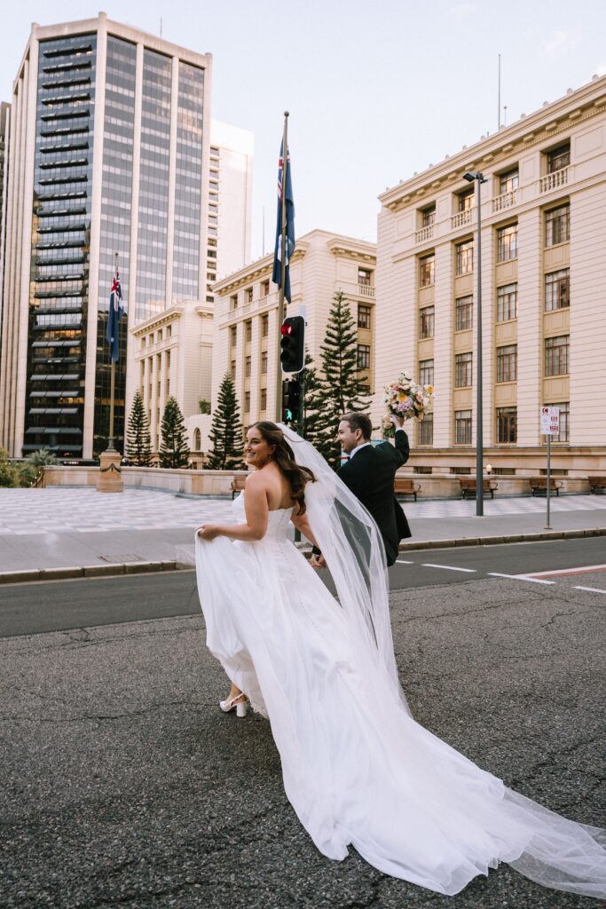 candid wedding photography of couple crossing the road in brisbane cbd 