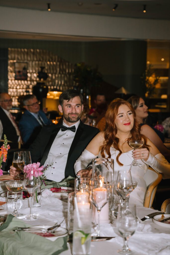 couple listening to speeches during wedding reception at w hotel brisbane