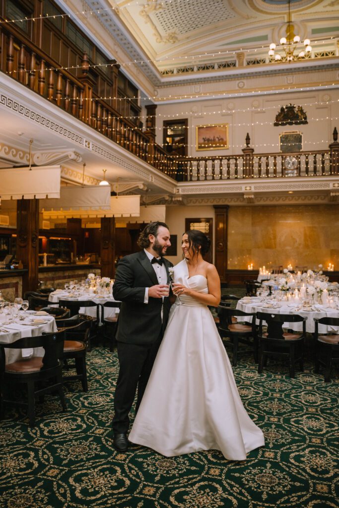 couple waiting for guests to arrive for indoor wedding reception at Tattersall’s Club