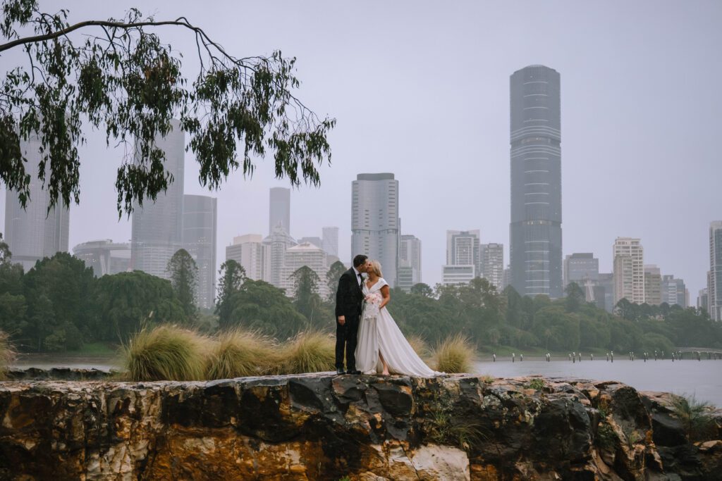 stunning portrait of couple kissing by the bay on an overcast day in brisbane