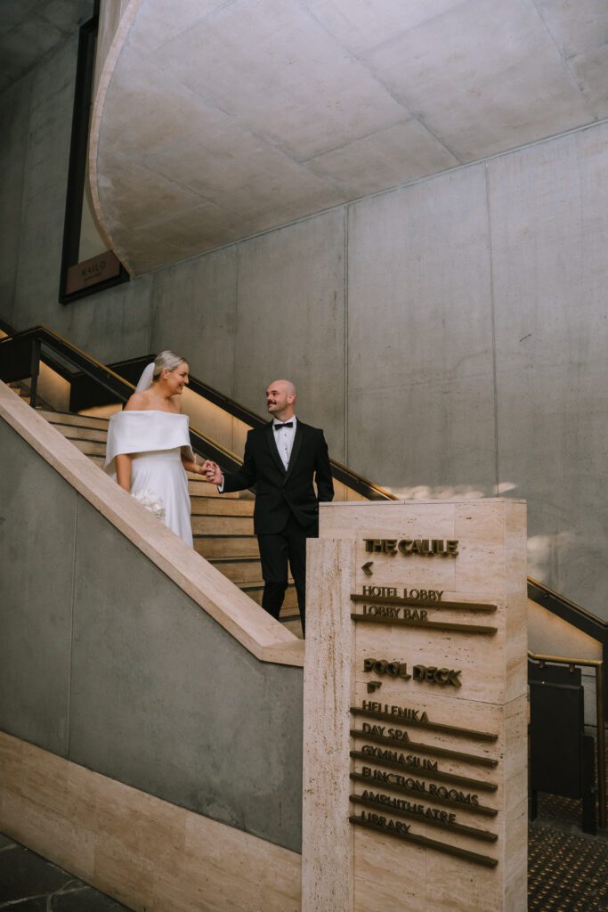 couple walking down the stairs at the calile hotel wedding venue in brisbane