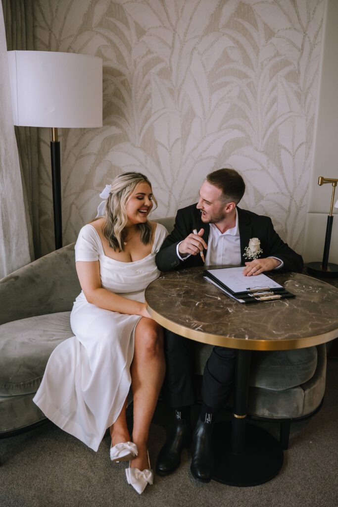 couple signing papers after intimate vows at Emporium Hotel South Bank in brisbane