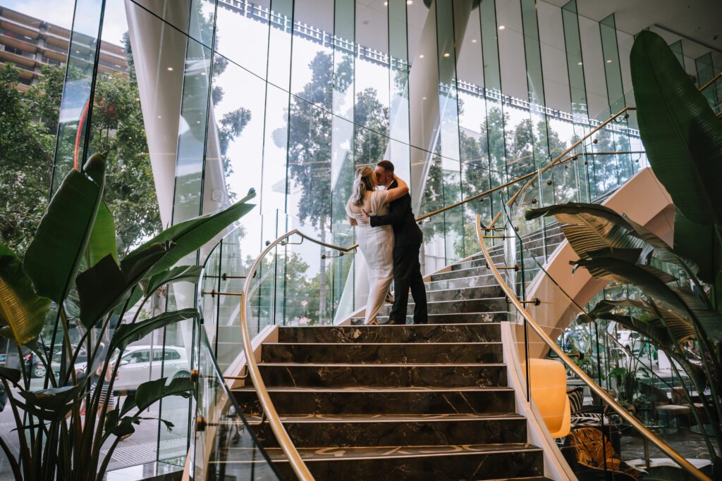 couple kissing on grand staircase at emporium hotel south bank in brisbane