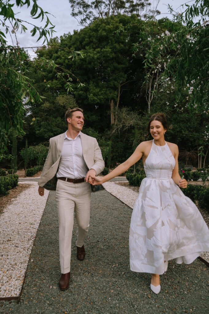 candid shot of couple running in wynmere estate gardens