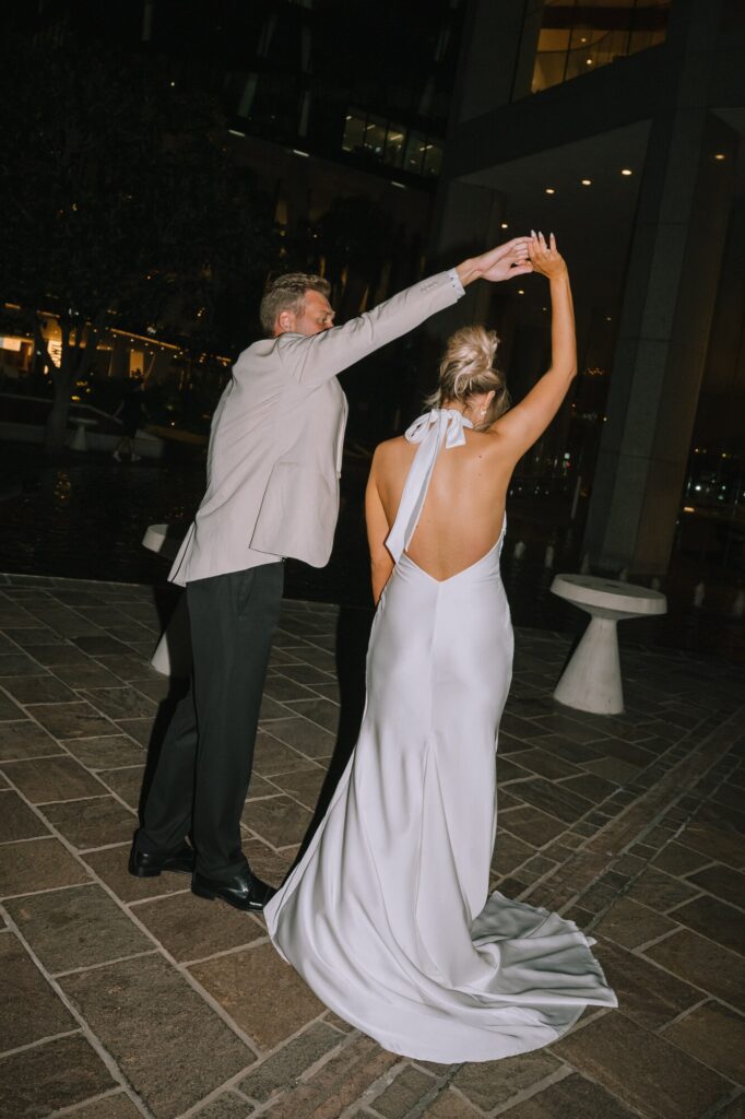 direct flash photography of couple dancing outside blackbird bar brisbane wedding venue
