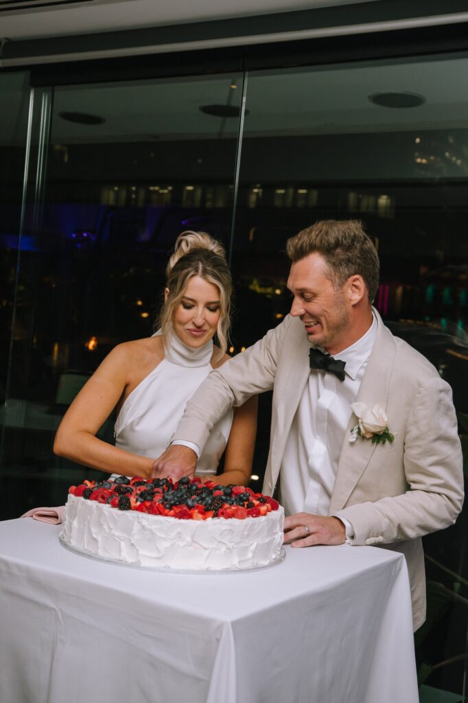 couple cutting cake during wedding reception at blackbird bar brisbane