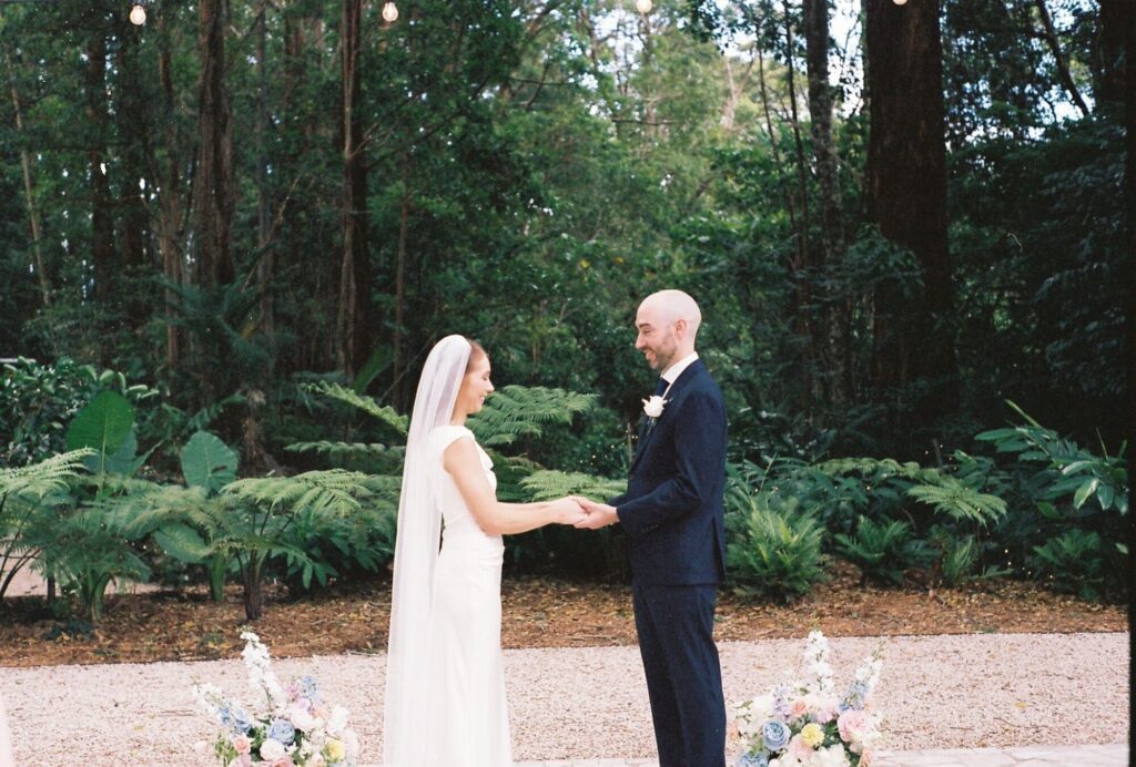 35mm film shot of couple holding hands during outdoor wedding ceremony on the sunshine coast