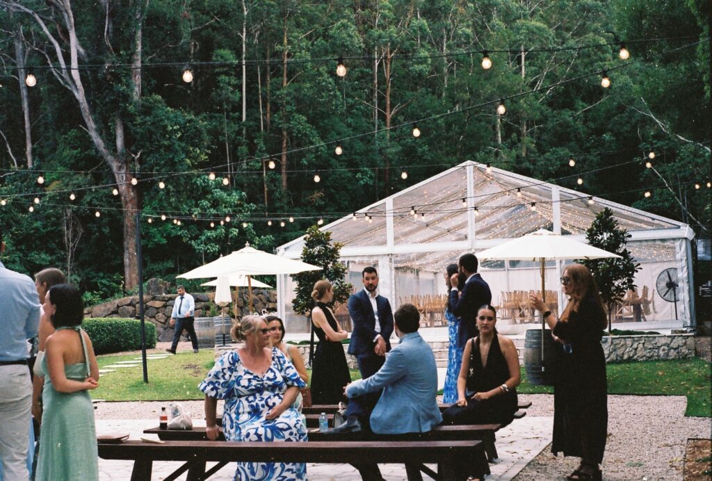 candid shot of guests after wedding ceremony captured on 35mm film camera