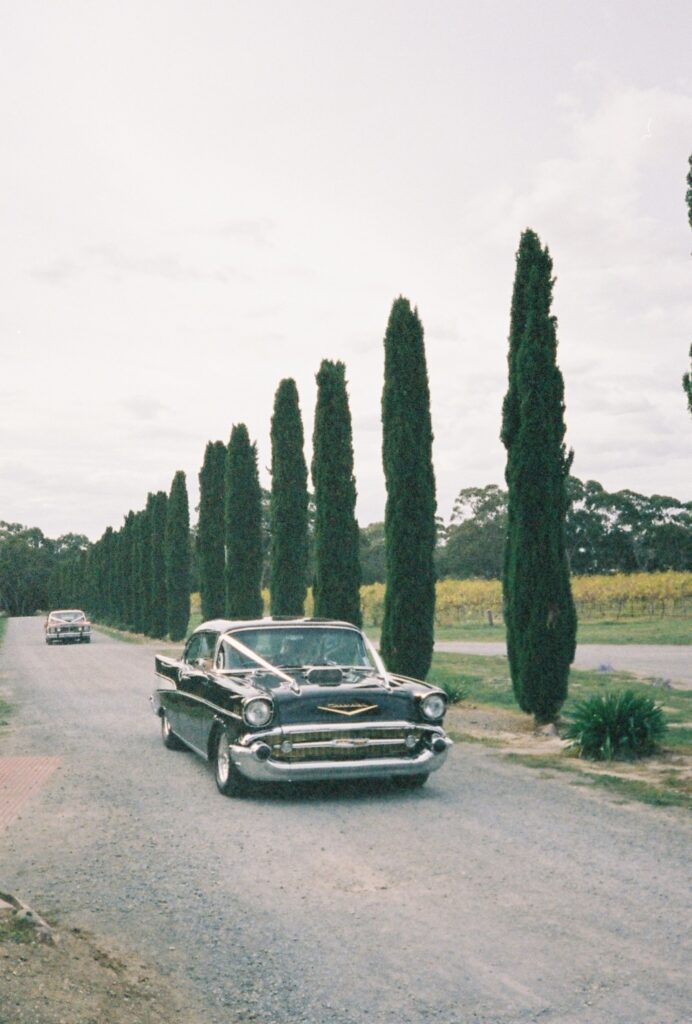 vintage wedding car arriving at wedding ceremony shot on 35mm film 