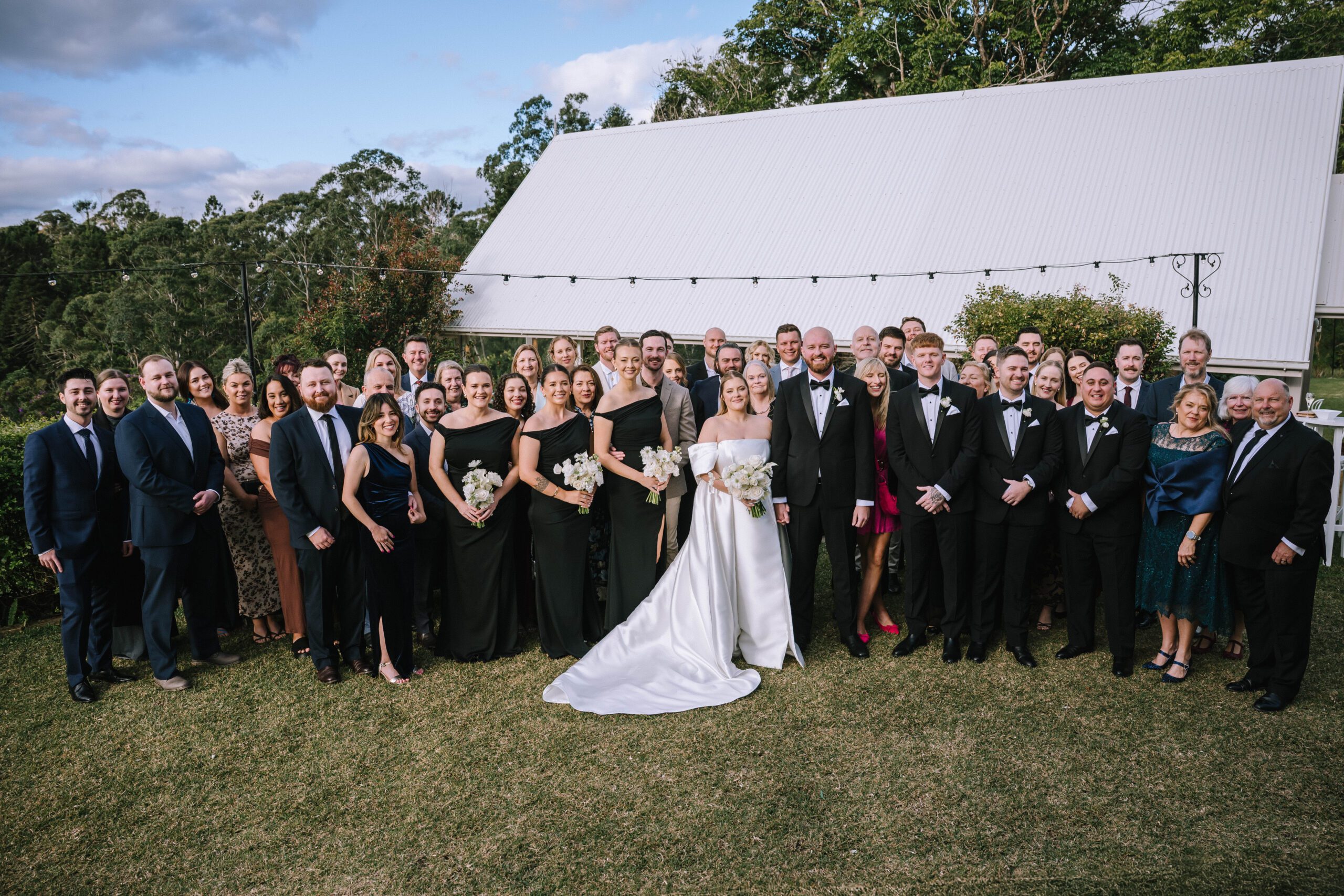 formal group portrait of couple with all wedding guests after the ceremony