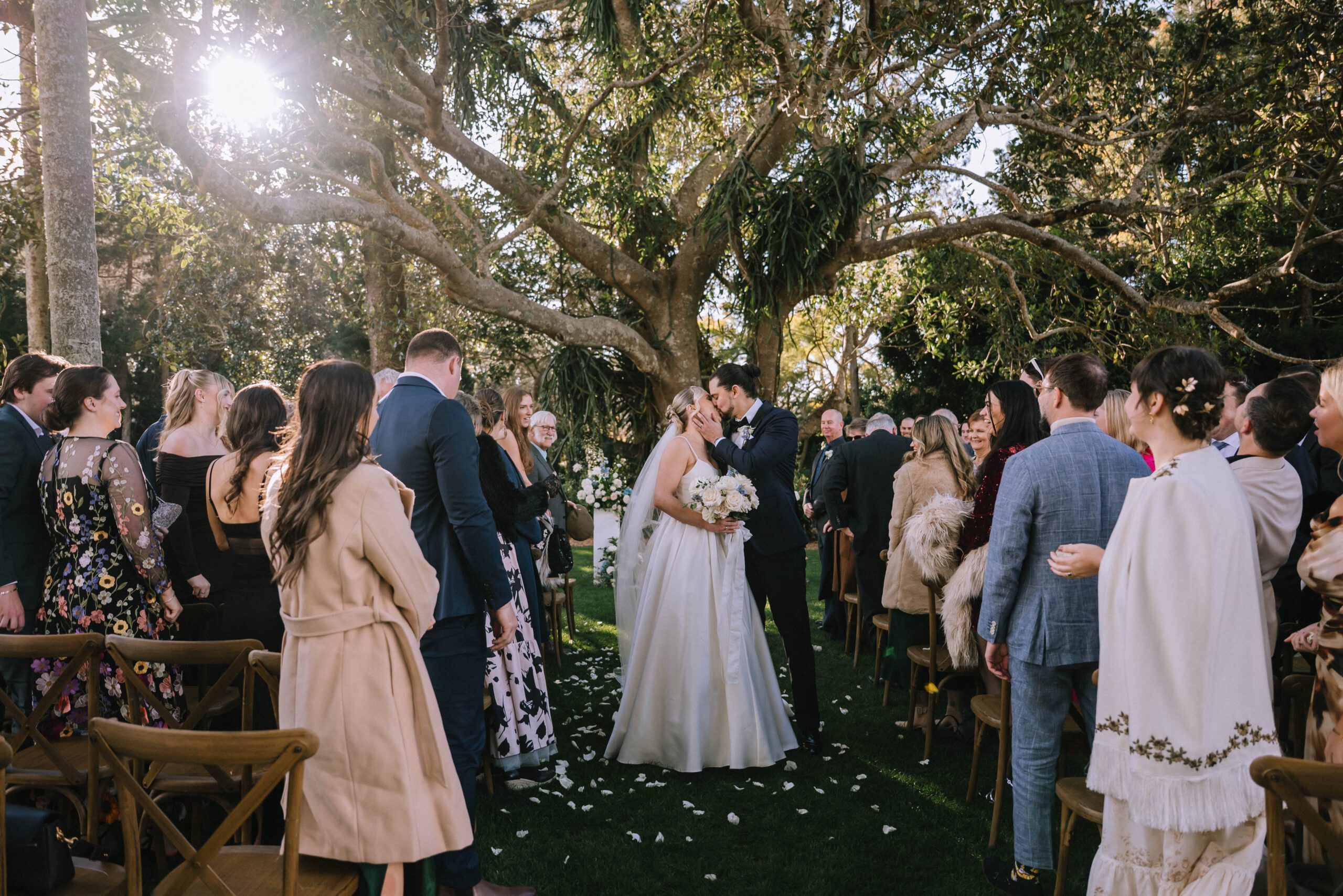 couple kissing during outdoor wedding ceremony