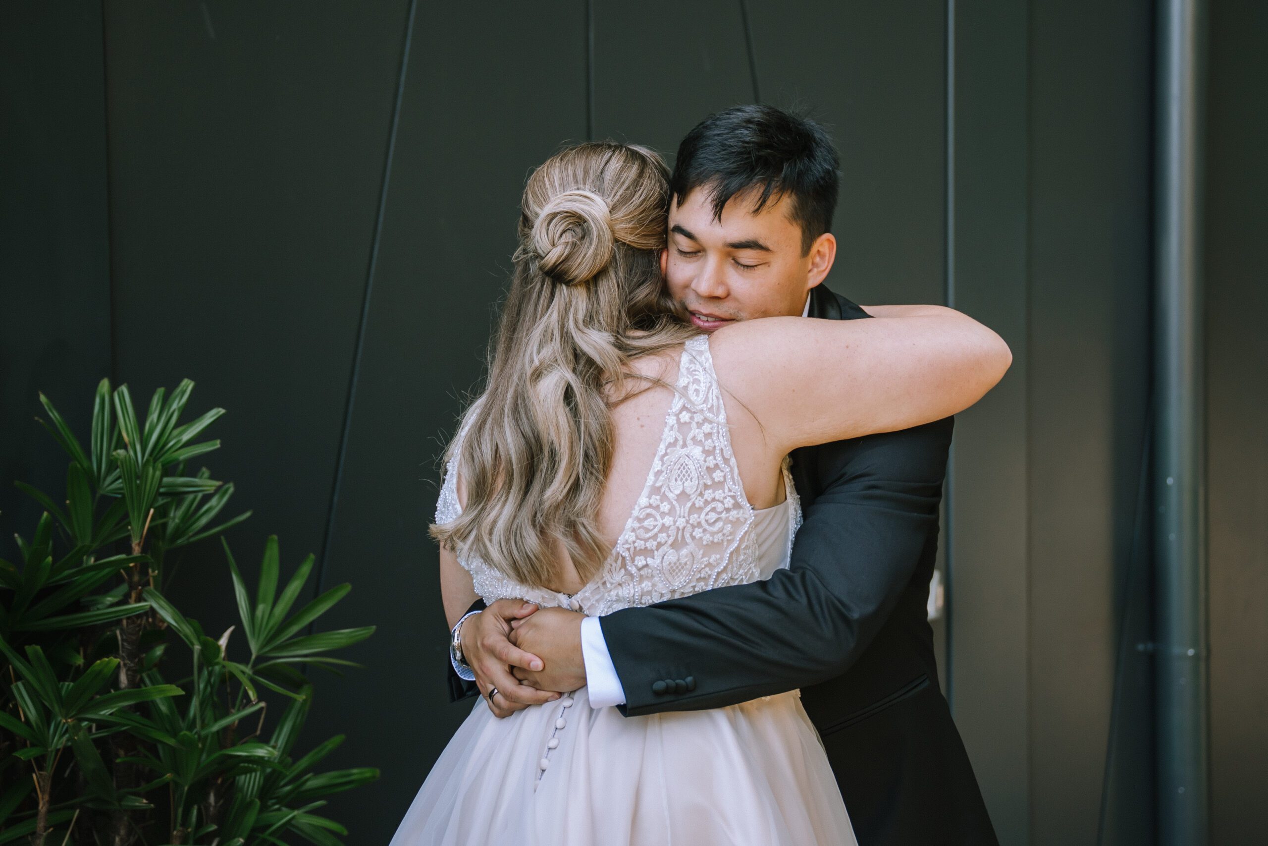 intimate moment of couple embracing after their first look at Crystalbrook Hotel