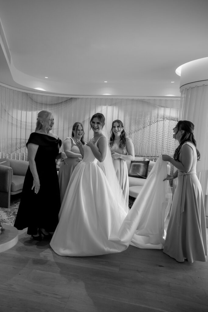 classic black and white portrait of bride with her mum and bridal party