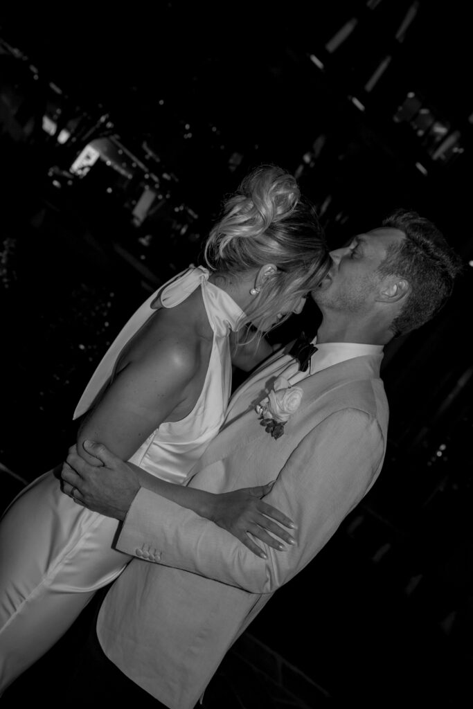 editorial style black and white portrait of couple embracing on the street