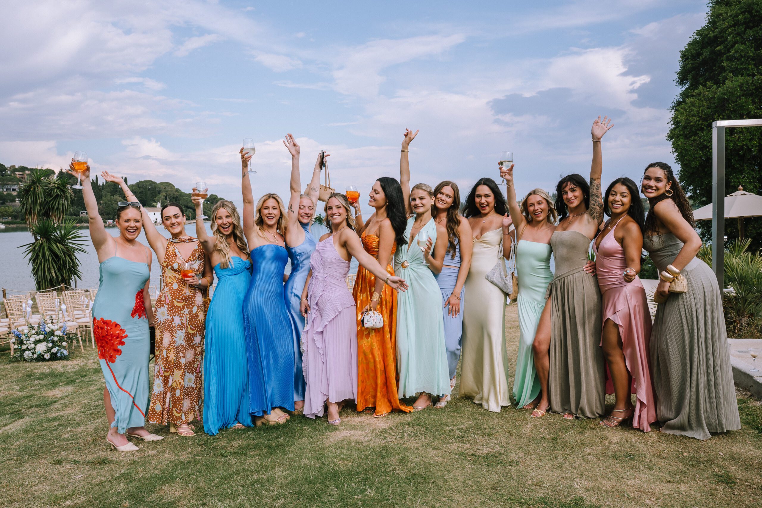 happy wedding guests in colourful dresses celebrating before wedding ceremony begins at Hyatt Ziva Corfu in Greece