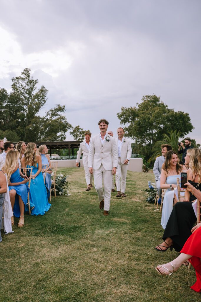 groom arriving at outdoor wedding ceremony at Hyatt Ziva Corfu in Greece
