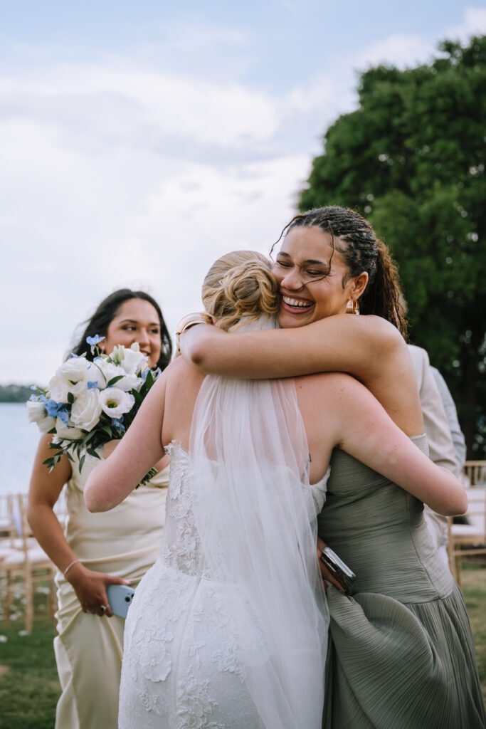 bride hugging a happy wedding guest after the wedding ceremony