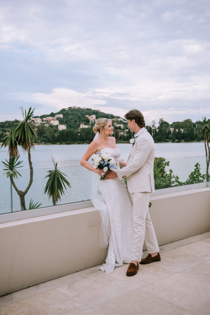 editorial portrait of couple leaning on the glass fence at Hyatt Ziva Corfu in Greece