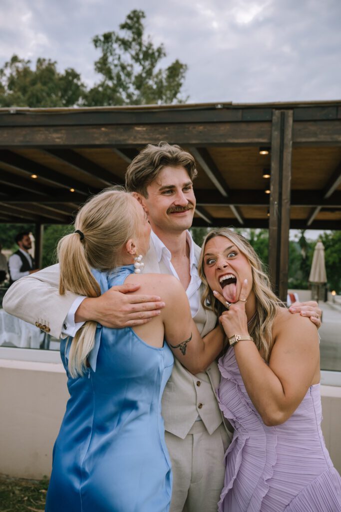 candid shot of groom hugging wedding guests after the ceremony