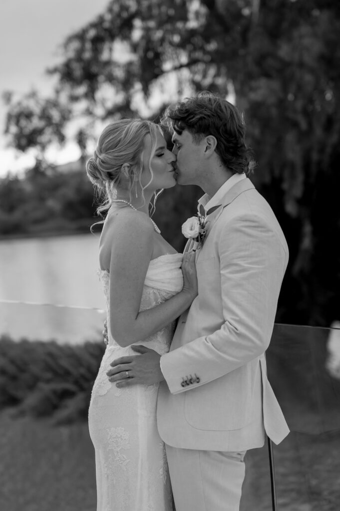 black and white editorial style portrait of couple kissing