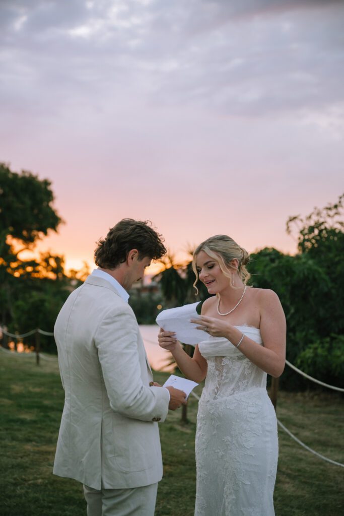 couple reading their private letters to each other with sunset in the background
