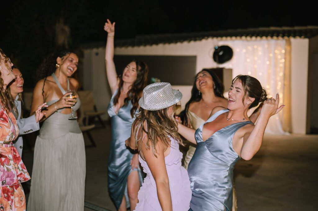 bridesmaids dancing with wedding guests during reception at Hyatt Ziva Corfu in Gouvia, Greece