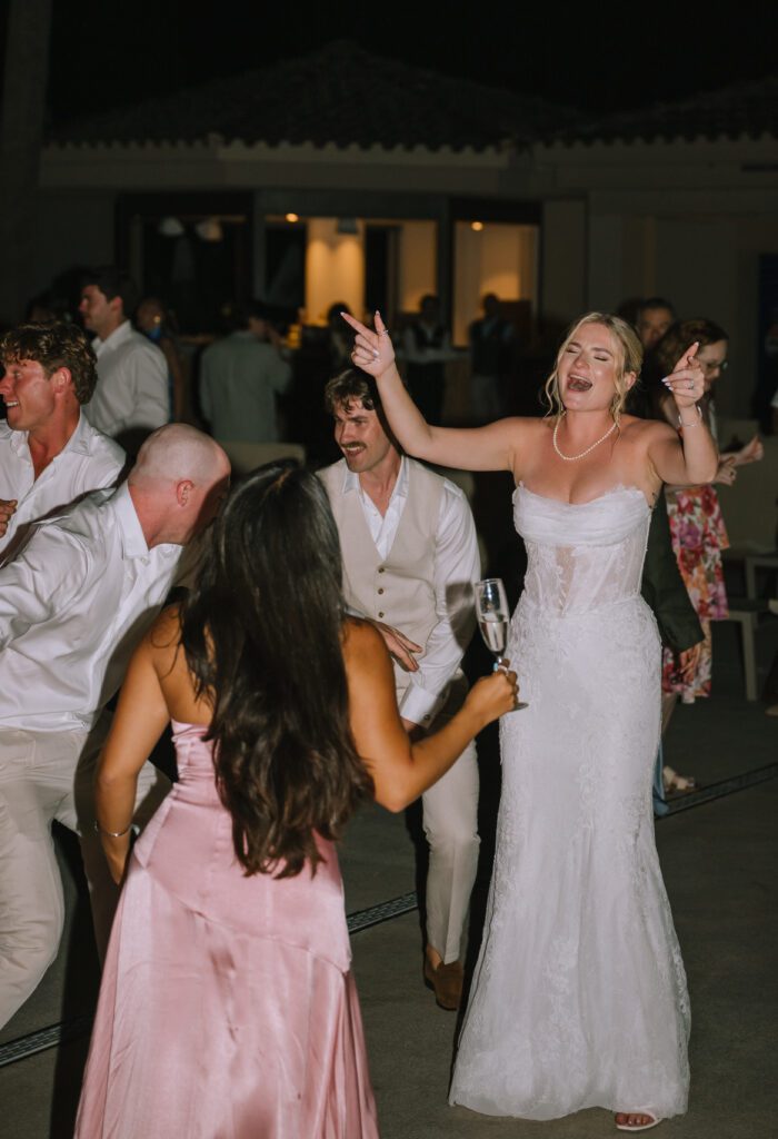 candid shot of couple on the dancefloor with their guests during wedding reception